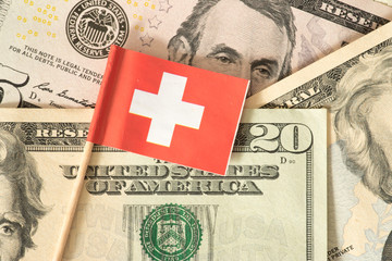 Flagge von Schweiz und Dollar Geldscheine im Hintergrund