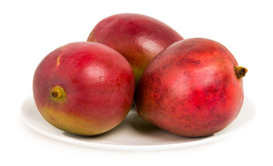 Mango on white plate isolated