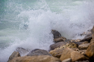 Wavy sea wallpapers crashing into the rocks on the beach, the intensity of sea breezes and storms during the season of nature.