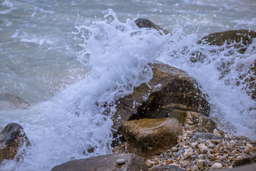 Wavy sea wallpapers crashing into the rocks on the beach, the intensity of sea breezes and storms during the season of nature.