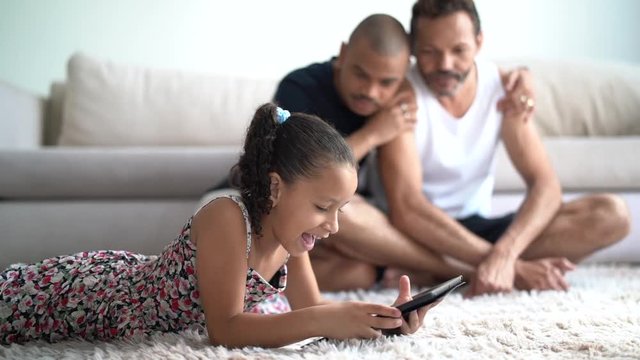 Gay Family with Adopted Child Using Tablet at Home