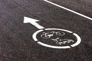 Fototapeta premium Bicycle, roller scates sign on asphalt paths on city park