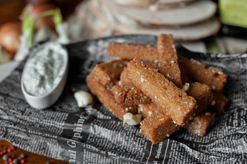 fried toasts with garlick sauce on a table