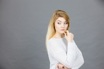 Blonde woman contemplating thinking about something