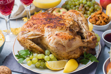 Baked chicken, mashed potatoes and wine glasses for dinner on the festive table.