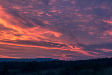 Fototapeta na wymiar Nice sunset clouds in blue hour with hills