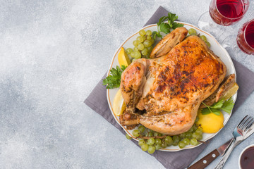 Baked chicken, mashed potatoes and wine glasses for dinner on the festive table. Copy space