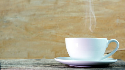 Cappuccino or latte art coffee. Free hand pouring some foam of milk on top. A white ceramic cup on the wood table with some coffee beans. The best food and drink in the world. Fresh energy everyday.