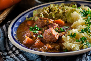 Traditional irish stew served with potatoes and cabbage