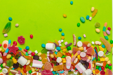 Fototapeta na wymiar Colorful candies on green background