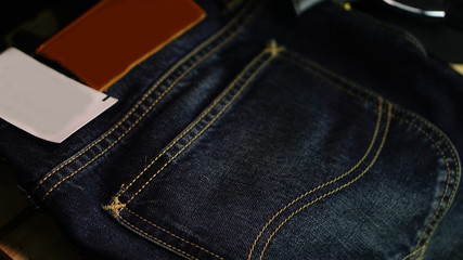 Blue jeans with leather label and red selvage. Jeans are type of garment and hard-wearing cotton...