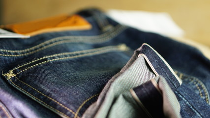 Blue jeans with leather label and red selvage. Jeans are type of garment and hard-wearing cotton twill fabric, typically made from denim or dungaree cloth.
