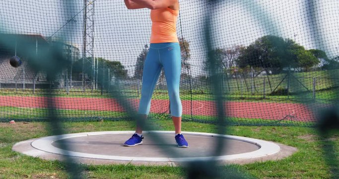 Female athlete practicing hammer throw 4k