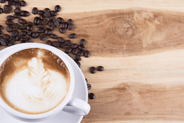 Cappuccino and latte art on the wood table. Free hand pouring some milk on the coffee. Morning breakfast with coffee.