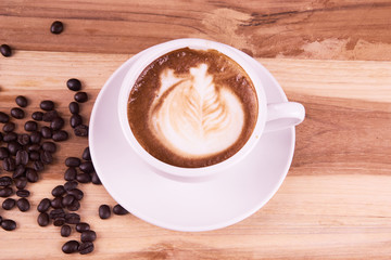 Cappuccino and latte art on the wood table. Free hand pouring some milk on the coffee. Morning breakfast with coffee.