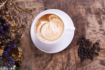 Cappuccino and latte art on the wood table. Free hand pouring some milk on the coffee. Morning breakfast with coffee.