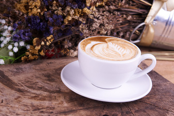 Cappuccino and latte art on the wood table. Free hand pouring some milk on the coffee. Morning breakfast with coffee.