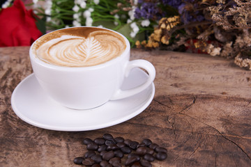 Cappuccino and latte art on the wood table. Free hand pouring some milk on the coffee. Morning breakfast with coffee.