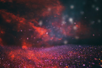 Red, black and gold glitter lights background. defocused.