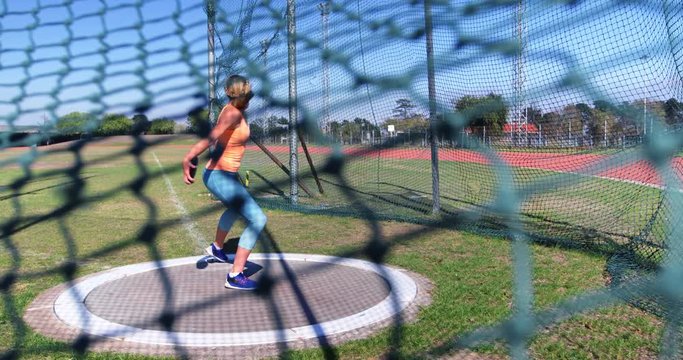 Female athlete practicing discus throw 4k