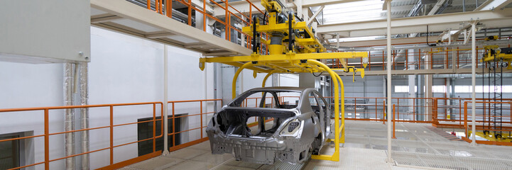 body of car on conveyor close-up. Automotive production line. long format. Wide frame