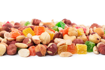 Pile of toasted nuts and candied fruit isolated on white background