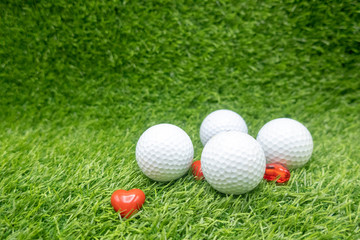 To golfer with love on Valentine's day with golf ball and red heart on green 