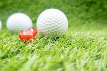 Happy Valentine's Day to golfer with love and golf ball on green grass 