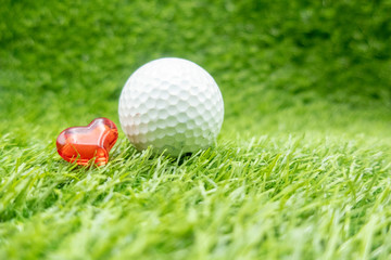 Happy Valentine's Day to golfer with love and golf ball on green grass 