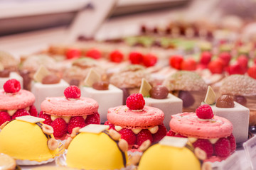 Various beautiful delicious pastries on a showcase in a French shop. - 234615192