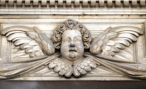 Angel on the portal of Santa Maria Corteorlandini church in Lucca, Tuscany, Italy