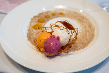 Colorful scoops of ice cream decorated with caramel and sugar