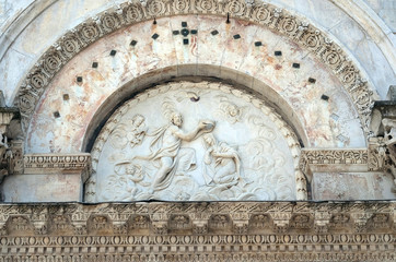 Obraz premium Coronation of the Virgin Mary, portal of Santa Maria Forisportam church in Lucca, Tuscany, Italy
