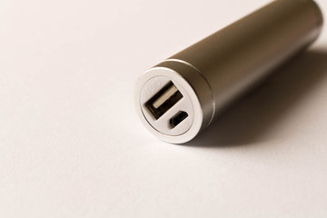 Silver powerbank on white background. The concept of electronic devices
