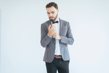 Handsome groom with bearded in formal tuxedo and suit in wedding day
