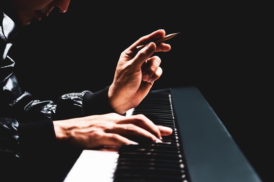 male songwriter hands composing a song on piano, song writing concept