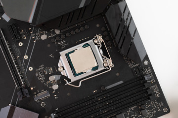 Top view of cpu on motherboard, computer parts and accessories, Electronics repair and upgrade on white desk background, copy space. Motherboard, processor cpu, cooler, radiator, flat lay.