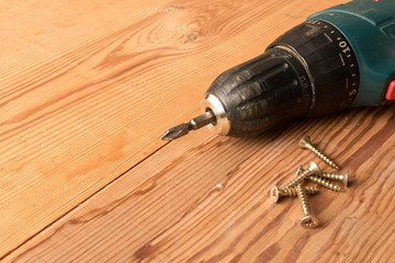 Screwdrivers and screws on a wooden table. The concept of work. Labor day