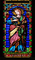 Fototapeta na wymiar Saint John the Evangelist, stained glass window in the San Michele in Foro church in Lucca, Tuscany, Italy