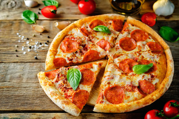 Pizza with pepperoni, tomato sauce and cheese