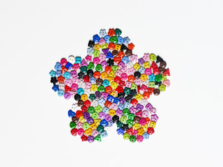 Image of flower made of multicolored  buttons. Isolated on white background