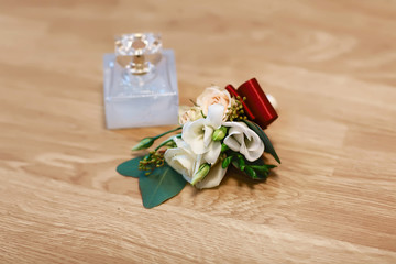 wedding accessories, bouquet and perfume bridal and bridal accessories, wedding details on a wooden background