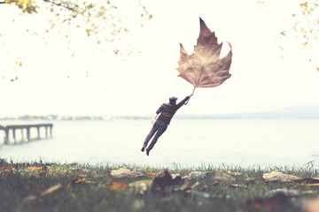 man flying with a leaf