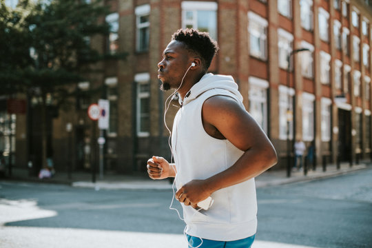 Athletic man running with earphones