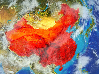 China from space on model of planet Earth with country borders. Extremely fine detail of planet surface and clouds.