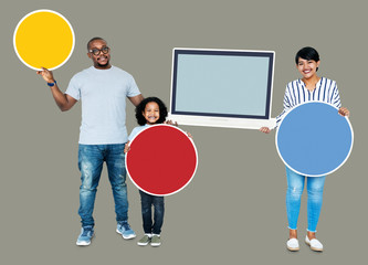 Happy family holding round boards and a screen