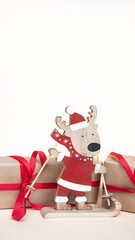 Wooden deer toy  and gifts. Copy space. Christmas holiday background.