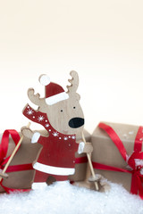 Christmas holiday background. Wooden deer toy  and gifts. Copy space.