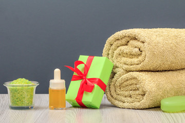 Spa composition with towel, gift box, oil, sea salt and soap.