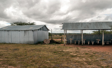 Fototapeta na wymiar Houses in ruins in a village in Kenya on a cloudy day